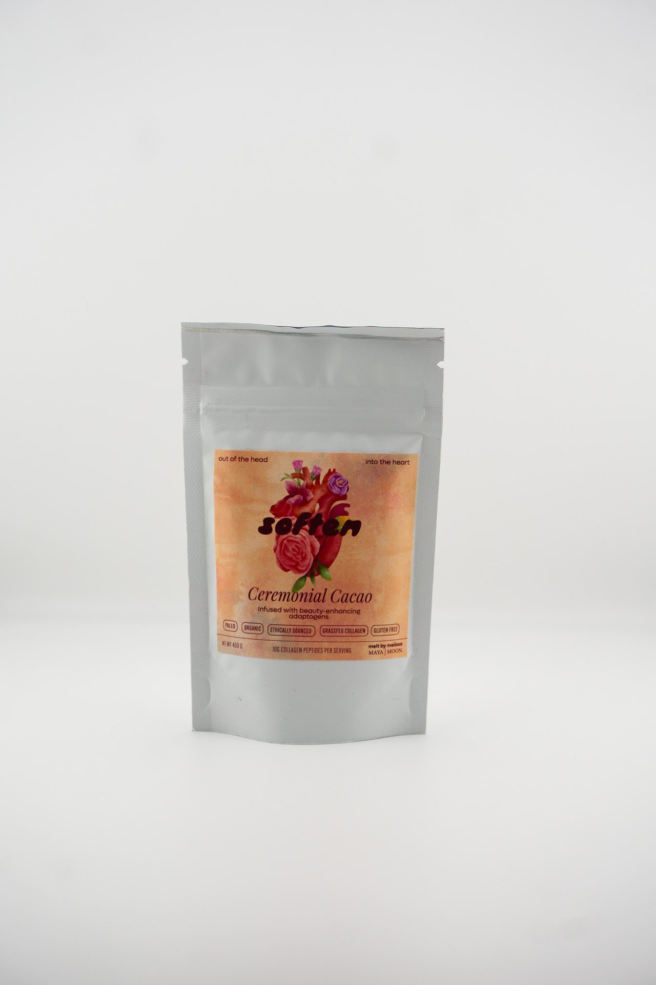 Silver packaging of ceremonial cacao with a colorful label on a white background