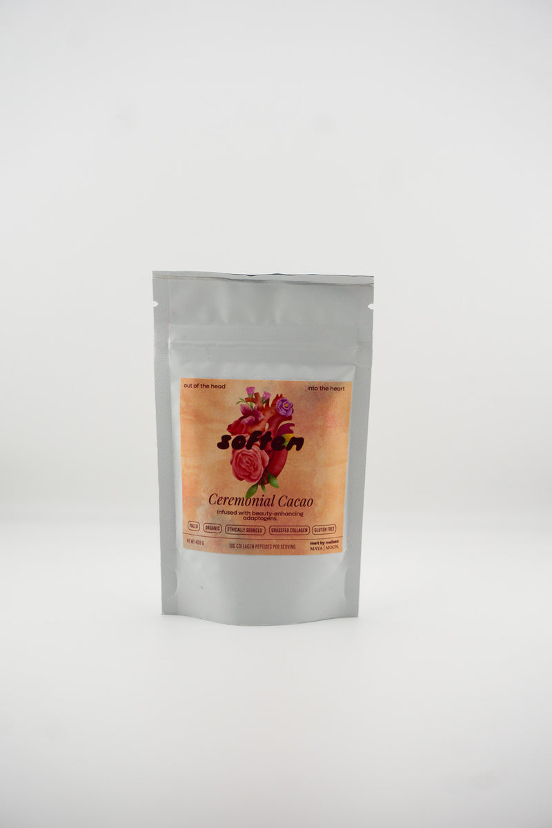Silver packaging of ceremonial cacao with a colorful label on a white background